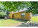 A view of the large grassy backyard and the back of the home at 9119 Woodgreen Way, Jonesboro, GA 30238