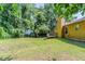 Spacious backyard featuring a well-kept lawn, a deck, and mature trees that provide ample shade at 9119 Woodgreen Way, Jonesboro, GA 30238