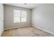 Bright bedroom featuring a window and carpeted floors, creating a comfortable and inviting space at 9119 Woodgreen Way, Jonesboro, GA 30238