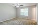 Large carpeted bedroom with ceiling fan and a big window at 9119 Woodgreen Way, Jonesboro, GA 30238