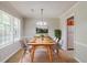 Bright dining room featuring modern light fixture, natural light, and neutral colors at 9119 Woodgreen Way, Jonesboro, GA 30238