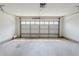 Spacious two car garage features a bright interior, white walls, and a large paneled garage door at 9119 Woodgreen Way, Jonesboro, GA 30238