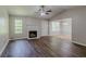 Spacious living room featuring wood floors, fireplace, and ample natural light at 9119 Woodgreen Way, Jonesboro, GA 30238