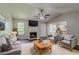 Cozy living room with fireplace, ceiling fan, and stylish decor at 9119 Woodgreen Way, Jonesboro, GA 30238