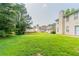 Large, grassy backyard with mature trees and surrounding homes at 9542 Canvasback Ct, Jonesboro, GA 30238