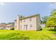 View of the back of the house with a grassy backyard and a small patio at 9542 Canvasback Ct, Jonesboro, GA 30238