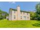 View of the back of the house from the yard, showing a chimney and siding at 9542 Canvasback Ct, Jonesboro, GA 30238