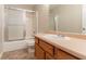 Bathroom with a shower-tub combo and vanity with a sink and wood cabinets at 9542 Canvasback Ct, Jonesboro, GA 30238