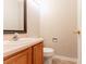Powder room with a modern mirror, neutral walls, and a wood vanity at 9542 Canvasback Ct, Jonesboro, GA 30238
