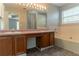 Bathroom featuring a double sink vanity, large mirror, and a shower-tub combo at 9542 Canvasback Ct, Jonesboro, GA 30238