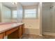 Bathroom featuring a shower, tub, and vanity with wood cabinets below a pink countertop at 9542 Canvasback Ct, Jonesboro, GA 30238