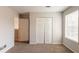 Bedroom with neutral walls, carpet flooring, window, and large closet with bi-fold doors at 9542 Canvasback Ct, Jonesboro, GA 30238