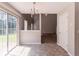 Dining area includes a chandelier, sliding glass door, and access to the stairway and other rooms at 9542 Canvasback Ct, Jonesboro, GA 30238