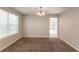 Dining room with neutral colors, new carpeting, a chandelier and large windows at 9542 Canvasback Ct, Jonesboro, GA 30238