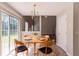Cozy dining area featuring a round table, chandelier lighting, and natural light from a nearby window at 9542 Canvasback Ct, Jonesboro, GA 30238