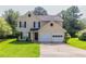 Inviting two-story home featuring a well-maintained lawn and a convenient two-car garage at 9542 Canvasback Ct, Jonesboro, GA 30238