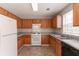 Functional kitchen featuring wooden cabinets, white appliances, and ample counter space at 9542 Canvasback Ct, Jonesboro, GA 30238
