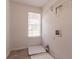 Laundry room with a window, utility sink, and tile flooring at 9542 Canvasback Ct, Jonesboro, GA 30238