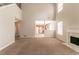 Large living room with fireplace, high ceilings, neutral paint, new carpet and view to the kitchen at 9542 Canvasback Ct, Jonesboro, GA 30238