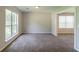 Living room featuring new carpeting, neutral paint and natural light from the windows at 9542 Canvasback Ct, Jonesboro, GA 30238