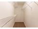 Walk-in closet featuring built-in shelving and neutral carpet at 9542 Canvasback Ct, Jonesboro, GA 30238