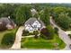 Aerial view of a beautiful two-story home with a lush green lawn and mature trees at 1023 Spruce Creek Ln, Lawrenceville, GA 30045