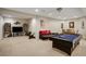 Finished basement offering a pool table, lounge area, and entertainment space at 1023 Spruce Creek Ln, Lawrenceville, GA 30045
