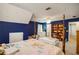Comfortable bedroom with star-themed vaulted ceiling, blue accent walls and furniture at 1023 Spruce Creek Ln, Lawrenceville, GA 30045
