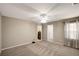 Bedroom features a ceiling fan, gray carpet, neutral color walls, and bright natural light at 1023 Spruce Creek Ln, Lawrenceville, GA 30045