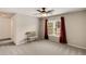 Neutral bedroom featuring a large window, chair, and carpeted floor at 1023 Spruce Creek Ln, Lawrenceville, GA 30045