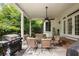Inviting covered patio with comfortable seating, perfect for outdoor entertaining at 1023 Spruce Creek Ln, Lawrenceville, GA 30045