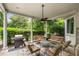 Charming covered patio with comfortable seating, ceiling fan, and a grill at 1023 Spruce Creek Ln, Lawrenceville, GA 30045