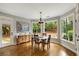 Dining room with natural lighting from large windows and a door with views of the landscaped yard at 1023 Spruce Creek Ln, Lawrenceville, GA 30045