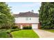 Charming home exterior with well-kept lawn, brick accents, and attached garage at 1023 Spruce Creek Ln, Lawrenceville, GA 30045