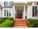 Inviting front entrance with brick steps and decorative wreaths on double doors at 1023 Spruce Creek Ln, Lawrenceville, GA 30045