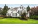Charming two-story home featuring a well-manicured lawn and lush landscaping at 1023 Spruce Creek Ln, Lawrenceville, GA 30045