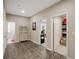 Inviting hallway with neutral tones and tile floor, leading to office and storage at 1023 Spruce Creek Ln, Lawrenceville, GA 30045