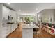 Bright eat-in kitchen with a large island, wooden floors, stainless steel appliances, and ample cabinet space at 1023 Spruce Creek Ln, Lawrenceville, GA 30045