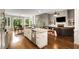 Modern kitchen with granite countertops, a large island, stainless steel appliances, and an eat-in table in front of large windows at 1023 Spruce Creek Ln, Lawrenceville, GA 30045