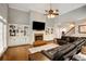Cozy living room with hardwood floors, a brick fireplace, built-in shelving, and comfortable seating at 1023 Spruce Creek Ln, Lawrenceville, GA 30045