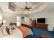 A serene main bedroom boasts natural light from its many windows, plus a tray ceiling and soft carpet at 1023 Spruce Creek Ln, Lawrenceville, GA 30045