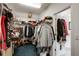 Walk-in closet with ample storage space, shelving and rods for hanging clothes at 1023 Spruce Creek Ln, Lawrenceville, GA 30045