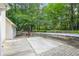 Backyard featuring a brick patio and mature trees at 1305 Kelly Nelson Dr, Lawrenceville, GA 30043