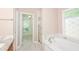 Soaking tub and glass shower enclosure in the bathroom at 1305 Kelly Nelson Dr, Lawrenceville, GA 30043