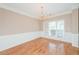 Bright and airy dining room featuring hardwood floors, white trim, and a large window at 1305 Kelly Nelson Dr, Lawrenceville, GA 30043