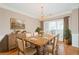Dining room featuring a rustic wooden table, chandelier, and natural light from the window at 1305 Kelly Nelson Dr, Lawrenceville, GA 30043