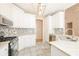 Well-lit kitchen featuring white cabinetry, stainless steel appliances, granite countertops, and tile flooring at 1305 Kelly Nelson Dr, Lawrenceville, GA 30043