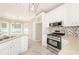 Bright kitchen with white cabinets, stainless steel appliances, granite countertops, and a stylish backsplash at 1305 Kelly Nelson Dr, Lawrenceville, GA 30043