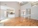 Open-concept living room with hardwood floors and views into the kitchen and dining areas at 1305 Kelly Nelson Dr, Lawrenceville, GA 30043