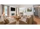 Cozy living room featuring a fireplace, hardwood floors, and ample seating with natural light at 1305 Kelly Nelson Dr, Lawrenceville, GA 30043